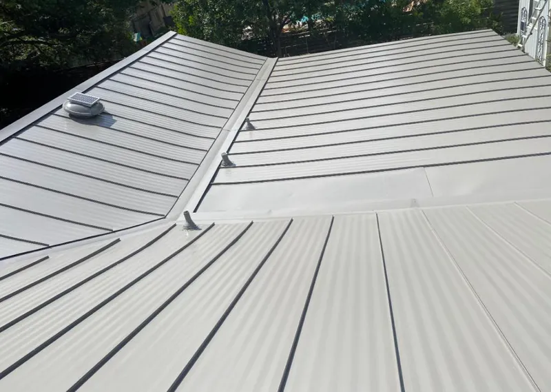 Solar attic fan installed on a metal roof for Roof Ventilation in Olive